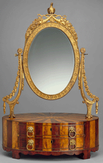 The dressing box made between 1800 and 1810 of mahogany, satinwood, white pine, gesso, gold leaf and glass was carved by McIntire with cornucopia, flowers and grapevines, swags and a small eagle.