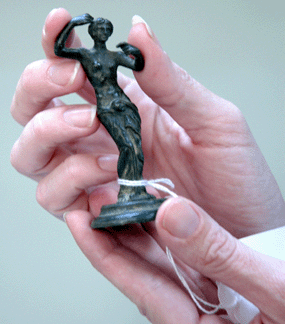 In Downing's hand, this bronze female figure is diminutive at 3 inches high but she fetched a hefty $2,100. Her same-sized counterpart, a bronze male figure, "The Philosopher,†brought $2,000.
