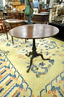 A cherry Chippendale tilt-top table thought to have been associated with the Chapin school sold for $8,625.