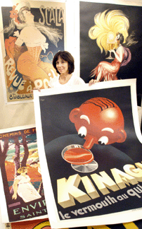 Muriel Egan of Frameworld Gallery, Boca Raton, Fla., displays some of the posters from her booth.