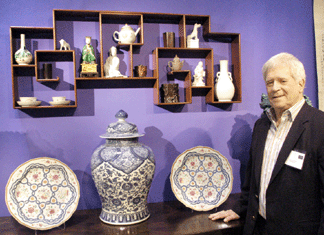 Peter Rosenberg of Vallin Galleries with a pair of rare Chinese Export chargers with crenellated rims that were made for the European market, and a monumental Eighteenth Century Chinese temple jar.