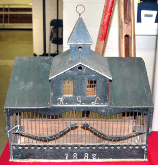 The folky birdhouse decorated with snakes was made in Essex County around 1882 and was for sale from Snow Antiques, Byfield, Mass.