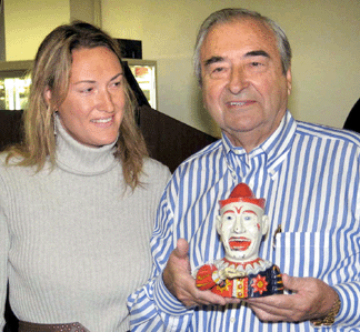 Fort Wayne, Ind., collector Stephen Steckbeck †with his daughter Samantha, one of five Steckbeck children at the sale †started buying mechanical banks in 1954 and never stopped. He holds a Shepard Hardware Co. Humpty Dumpty, $9,775. A companion trade card fetched $805.