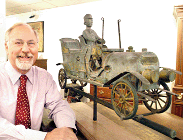 Auctioneer Stephen Fletcher had plenty to smile about as the weathervane in the form of an early automobile became the top lot of the auction. Originally mounted atop a building in nearby Lexington, Mass., it sold for $941,000 to telephone bidders Jerry and Susan Lauren.