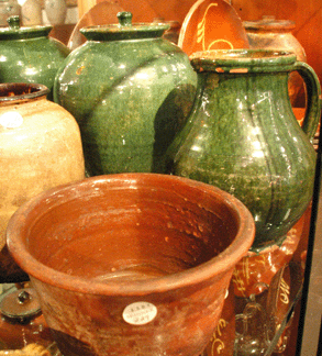 A small collection of redware included the covered ovoid jar in a vibrant green glazed, attributed to Bristol County, Mass., rear, selling at $11,750, while the pitcher in a similar glaze, right rear, also did well at $5,288.