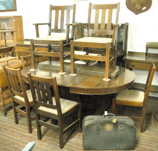 The generic 12-piece Mission oak dining suite with china cabinet, sideboard, server, table with five leaves, six side chairs and two armchairs sold for $2,070.