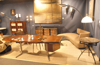 An Osvaldo Borsani rosewood desk and Taichiro Naka, sofa, circa 1956, with an off-center back at Donzella 20th Century Gallery, New York City.