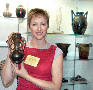 Suzanne Perreault of David Rago Arts and Auction Center, Lambertville, N.J., with a prized George Ohr piece.