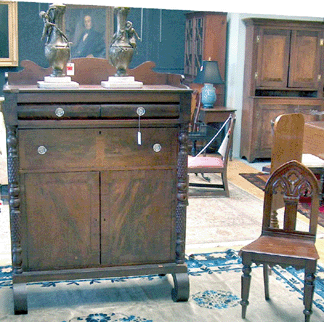 The tall mahogany server was believed to be of Southern origin, selling for $1,560, while the Gothic revival chairs were $672.