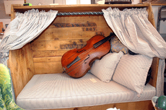 Cottage Treasures, Long Valley, N.J., offered an inviting spot to rest during the show, decorated in blue-gray ticking and with musical accompaniment.