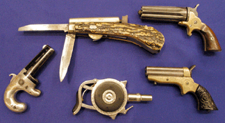 An interesting selection of unusual pistols ranging from a Chicago Firearms palm pistol to a stag-handled percussion knife pistol. 