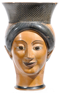 Terra cotta vase in the form of a woman's head, Greek, Attic, red-figure, white ground, circa 500‴90 BC, signed by Charinos as potter, attributed to the Charino class of head vases, height 8¼ inches. Lent by the Republic of Italy, 2008. Photo: Direzione Generale per i Beni Archaeologici, Ministero per i Beni e le Attività Culturali.