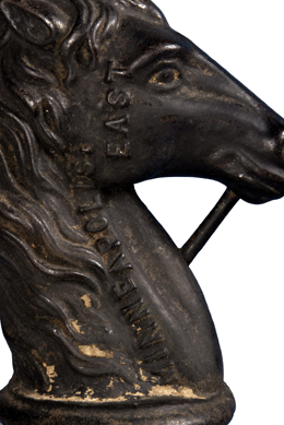 A detail of the foundry mark on a horse head finial made by Herzog Fence Works, Minneapolis, Minn.