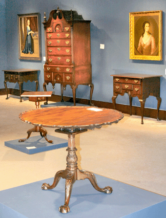 Christie's led with the Stevenson family Chippendale mahogany scalloped top table. Consigned by the Dietrich American Foundation, the table, attributed to Thomas Affleck with carving attributed to Nicholas Bernard and Martin Jugiez, went to Ohio dealer G.W. Samaha, underbid by Maryland dealer Milly McGehee, for $5,417,000, an appreciation of more than 500 percent since its sale in 1990 for $1.2 million, then an auction record. Also to Samaha went a Federal cherrywood tilt-top candlestand with decorative vine and urn inlays, visible behind the tea table, for $385,000. It is attributed to Nathan Lombard of southern Worcester County, Mass. Against the wall, center, the Andrew Family Chippendale mahogany high chest of drawers, possibly by Benjamin Frothingham of Charlestown, Mass., fetched $1,049,000 from Pennsylvania dealers C.L. Prickett Antiques. Left, an oil on canvas portrait of a young girl, possibly by Gerardus Duyckinck of New York, passed at $40/60,000. Right, a portrait, possibly of Phila or Richa Franks of New York, made $39,400, just short of the low estimate. 