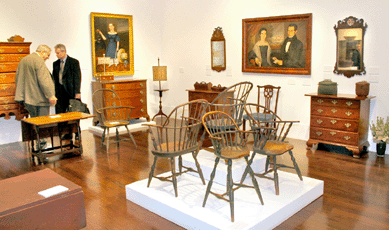 Riordan loved Windsors. In the foreground, left, is a green-painted sack back highchair, probably from New York, $49,000. A Connecticut sack back armchair to its right, $27,400. Facing rear are two Rhode Island Windsors, $5,000 and $4,375. Joseph Whiting Stock's "Portrait of Martha Otis Bullock,†left, $145,000, and, right, "A Double Portrait of Mr and Mrs Job Babcock, Sag Harbor, Long Island†by Orlando Hand Bears, $115,000. From left, Stonington, Conn., area flattop highboy, $11,875; Connecticut bow front chest, possibly Hartford County, $15,000; ivory swift on mahogany base, $6,875; pair of cherrywood knife boxes, center, $7,500; Connecticut side chair attributed to Felix Huntington, Norwich, $15,000; and, far right, Connecticut cherry chest of drawers, probably Colchester, $32,200.