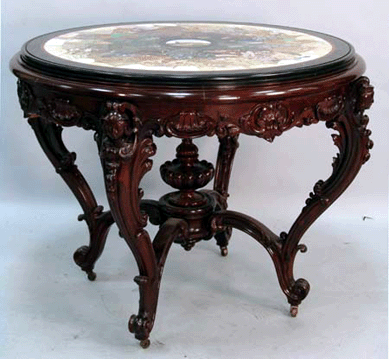 The Alexander Roux center table with a pietra dura top and a micromosaic center medallion, marked with the Roux paper label, sold at $23,000. 