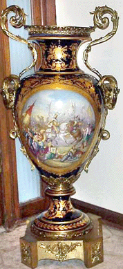 A pair of 3½-foot Sèvres cobalt palace urns (one shown) with hand painted French scenes and bronze mounts topped off at $24,570.