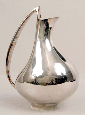 A Georg Jensen sterling silver water pitcher, designed by Henning Koppel, #992, approximately 43 troy ounces, 11 inches high, fetched $22,420.
