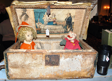 The cowhide box retained bits of the original fur and was lined with pages from an 1832 newspaper. It, along with a charming doll and a jolly clown, was offered by Kenneth Earl Reid of Andover, N.H.