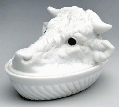 A steer's head covered dish of opaque white milk glass more than doubled its presale high estimate to sell for $3,955 to a private collector bidding in the gallery. On a swirled rib base, the piece made by Challinor, Taylor & Co. in the fourth quarter of the Nineteenth Century stood 5 inches high and featured striking nonoriginal applied eyes.