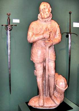 Armor expert Peter Finer of London and Ilmington, England, had the perfect marble effigy of a swordsman, south Germany, 1580‱610, $560,000. Flanking the sculpture was a German sword at left, circa 1520, $48,000, and a Scottish Lowland two-handed sword at right, $120,000.
