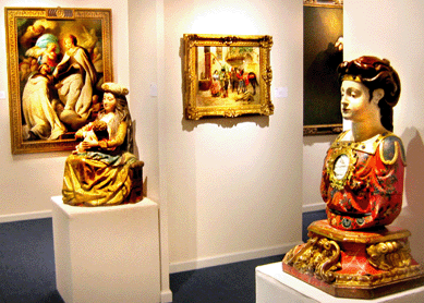 The religious sculpture offered by Artemisia Arte Antica, Madrid, included a Spanish Fifteenth Century Virgin and Child and a Seventeenth Century reliquary bust in the foreground.