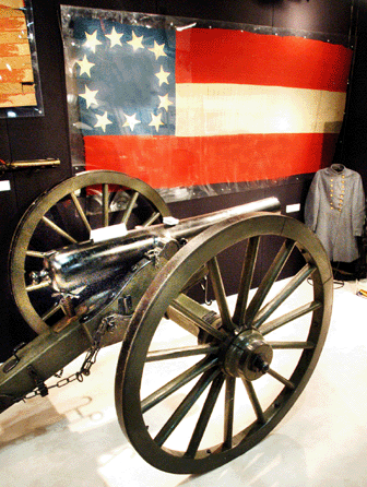 The Civil War cannon used at the Battle of Gettysburg was $85,000 at Christopher Mitchell, Daphne, Ala. The flag in the background flew at the headquarters of Confederate General Gustavus Smith and was $70,000.