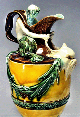 A detail of a majolica ewer, one of a pair, late Nineteenth Century, that measure 17 inches tall and were designed by John Flaxman. They are marked "Wedgwood,†"236,†"AAQ†and "V.• style=