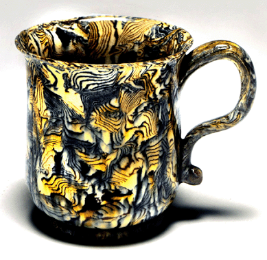 From the Wedgwood-Whieldon period is this agateware mug, mid-Eighteenth Century, 3 inches tall.