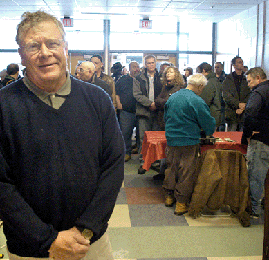 Manager Steve Allman became the manager of the popular Holliston Antiques Show 30 years ago. As is the case every year, a long line of enthusiastic shoppers await opening.