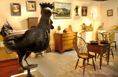 A rooster weathervane surveys the offerings at Sidney Gecker American Folk Art, New York City.