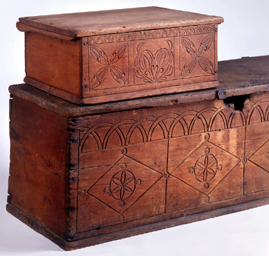 The Seventeenth Century chest was found in a barn in Hampton, N.H., and is part of the Kettell collection at the Concord Museum. It is scratch carved with double lunettes and geometric lozenges, one of which was compressed to meet the end of the board. The opening for the lock was probably chewed out by rats. The pine document box, from the same area and the same period, is decorated similarly and is from the Brodrick collection.