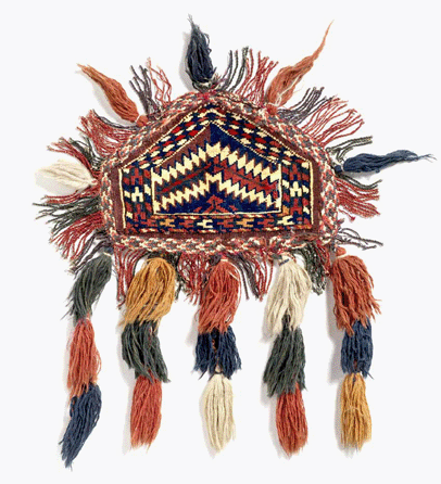 A camel knee pad demonstrates the highly specialized functions of weavings in the Turkmen society, which inhabited a swath of territory from Central Asia to Syria. This is one of a pair, woven by a young Turkman woman in preparation for her wedding. They would have been tied around the knees of the camel that carried her in her bridal procession.