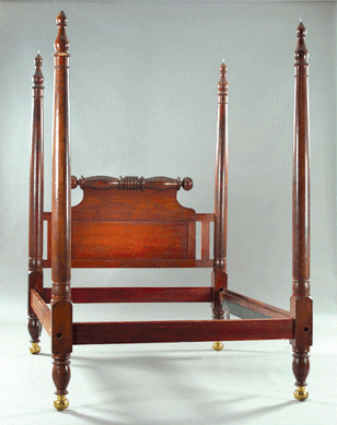 An early American lathe-turned cherrywood and brass footed four-post bed, second quarter Nineteenth Century, sold for $10,200. 