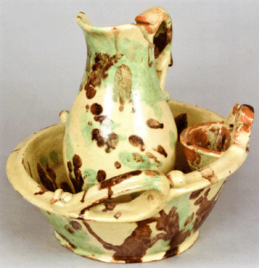 A Shenandoah Valley redware pitcher and washbowl set, attributed to J. Eberly & Co., took $25,875.
