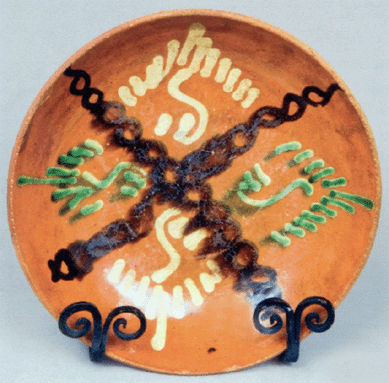 A Shenandoah Valley slip decorated redware plate, attributed to J. Eberly & Co. or S. Bell & Son, both of Strasburg, Va., was from a 60-year Midwestern collection and sold for $25,300.