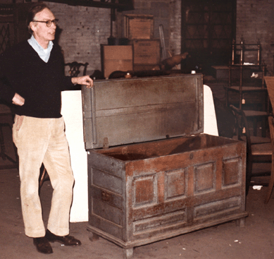 Kindig Antiques entered the Great Depression with liquid funds and low overhead, enabling the firm to buy well and accumulate a large, diverse inventory. In this circa 1980 photograph taken at the Kindig warehouse, Joe Kindig III shows a New Jersey blanket chest.