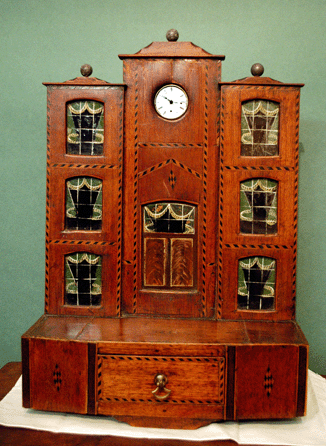 An interesting hutch in the form of a lodge, complete with reverse painted on glass windows at Hare's Ltd, Palmyra, N.Y.