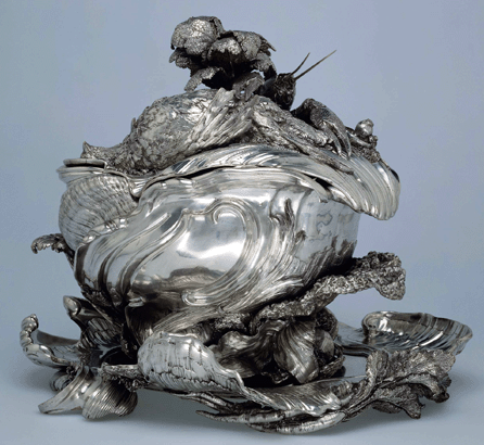 The silver soup tureen wrought in the form of a shell with a fluted lid covered with realistic putti, crayfish and vegetables, circa 1735‱740, was made by Henri-Guillaume Adnet and Francois Bonnestrenne under the direction of Juste-Aurèle Meissonier, the Turin-born master goldsmith.