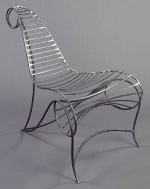 French designer André Dubreuil, who works in England, created the steel Spine Chair in 1986 after the rococo garden chairs of prior eras. It is a simple design rendered fanciful by complex undulations.