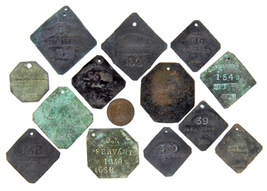 A collection of 13 rare and genuine slave badges and one slave token sold for $184,000.