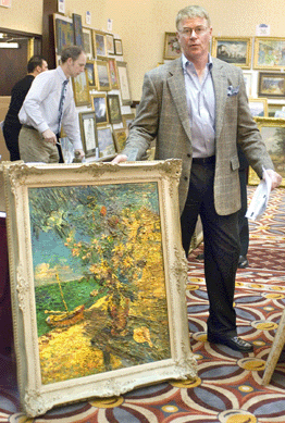 Steve Gass with David Burliuk's oil on canvas, "Lake Scene with Flowers and Sea Shells,†shortly after it sold for $47,800, making it one of the top lots. 