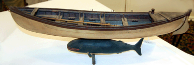 A Nineteenth Century model of a whaling dory atop a carved whale sold for $4,680.