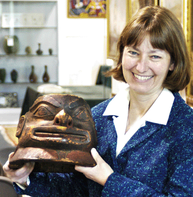 Auctioneer Rosie DeStories with the helmet that sold for $2.185 million.