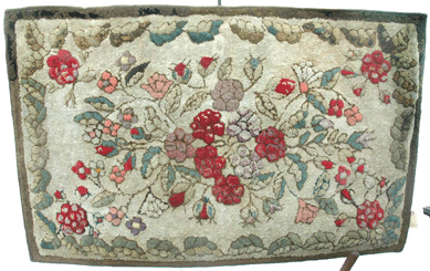 This Waldoboro floral rug was being offered by Colette Donovan, Merrimacport, Mass. ⁍ay's Antique Market
