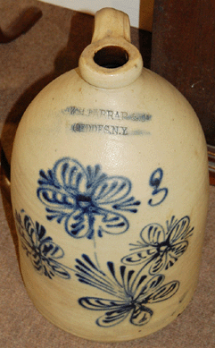 Stamped "W.H. Farrar / Geddes, N.Y.,†the stoneware jug realized $1,596.