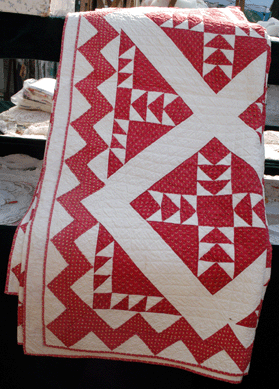 A late 1800s quilt with a pleasing geometric pattern at Haidi Campbell, Westwood, N.J. Upon close examination, the quilt shows a grouping of hearts stitched in the white ground around the border.