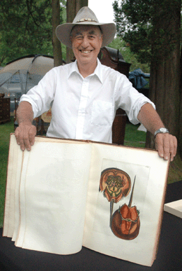 George Dickenson of Maile's Antiques, Colonia N.J., with a rare 1711 copy of a treatise on shells and minerals, showing a hand colored print of a horseshoe crab.