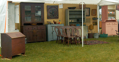 Saturday at Farmington was a gray day until one reached Debbie and John Schleister's exhibit with all the colorful painted furniture. The Washington Court House, Ohio, dealers were exhibiting for the first time at this show.