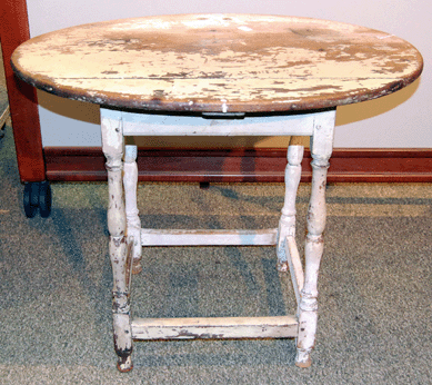 An Eighteenth Century New England maple oval top tea table with legs on a stretcher base attracted a lot of presale interest, but sold on the phone for $7,188. 